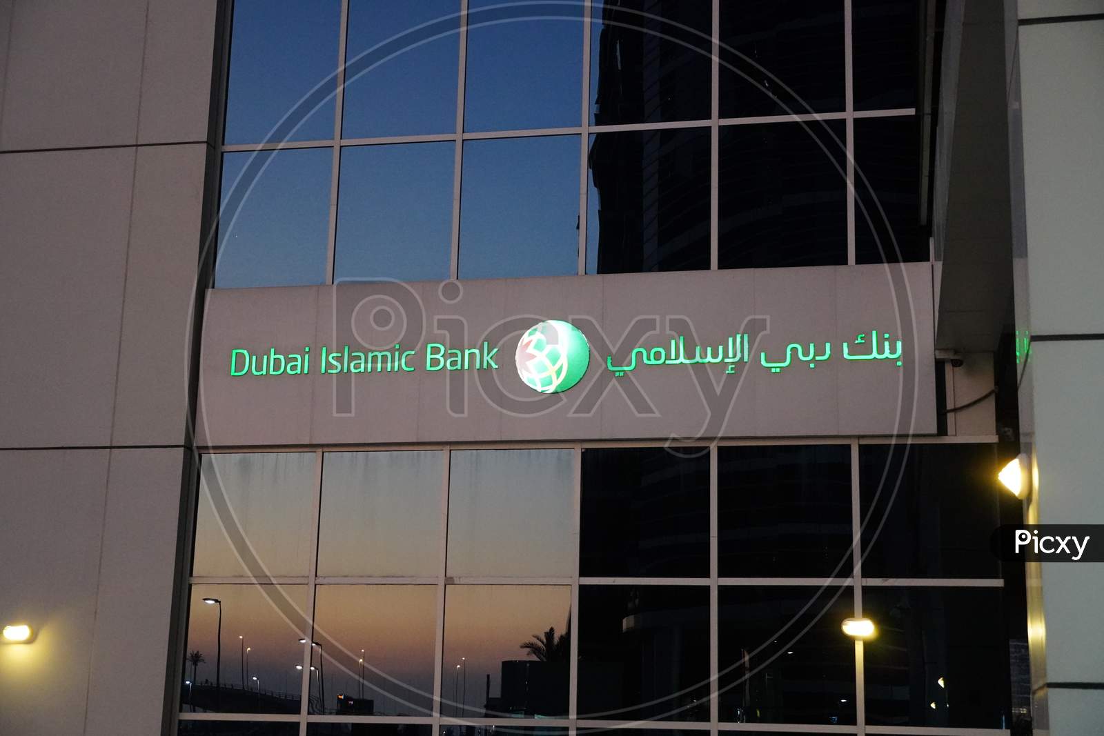 Dubai Uae December 2019 - Dubai Islamic Bank A Major Middle Eastern Banks Building Sign Logo On Large Building In Evening. Night Time View.