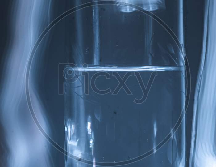 Glass of water in light blu background