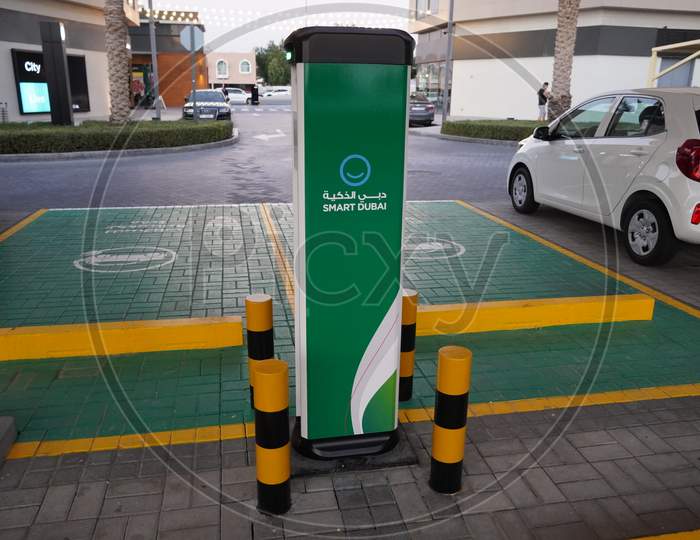 Smart Dubai Car Charging Stations In Parking Lot. Charging Modern Electric Cars (New Energy Vehicles, Nev) On The Street Station. Power Supply. Electric Car Charging Station - Dubai Uae December 2019
