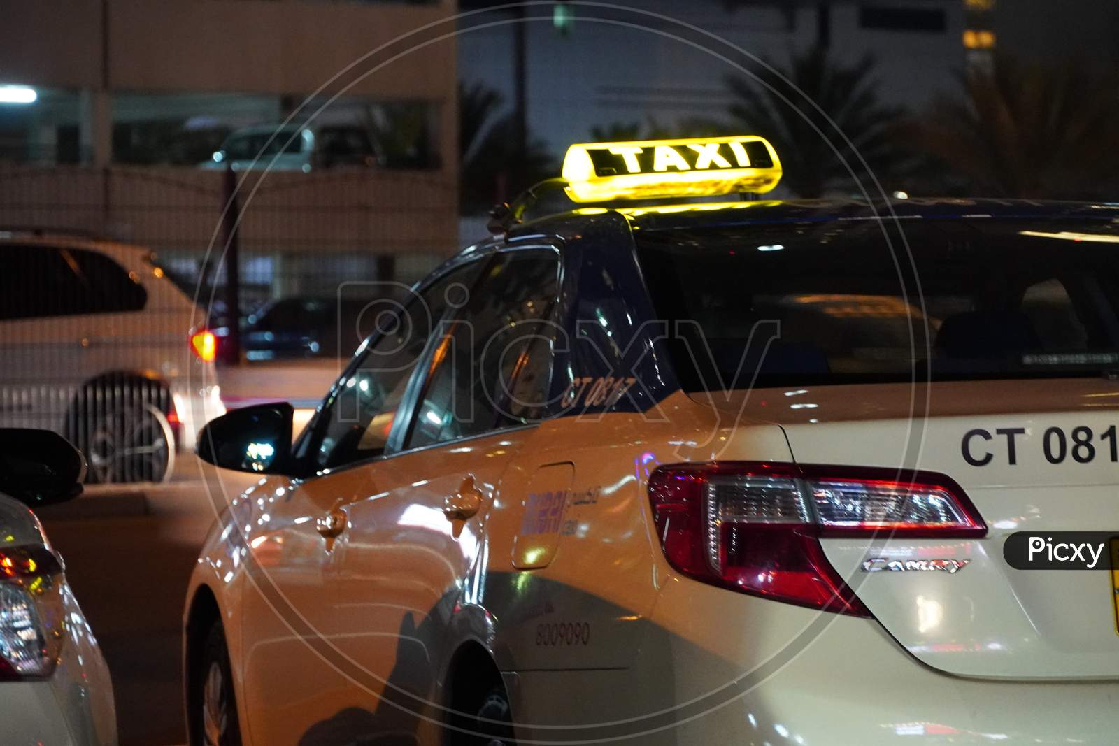 Dubai Uae - November 2019: Dubai Public Taxi Is Parked In A Parking Lot At Night. Taxi In The City Of Dubai - Dubai Has An Extensive Taxi System Rta.
