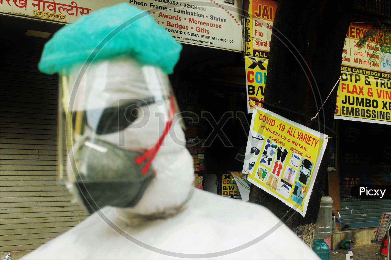 A shopkeeper displays a PPE kit makeshift mannequin by the roadside, in Mumbai, India on June 20, 2020.