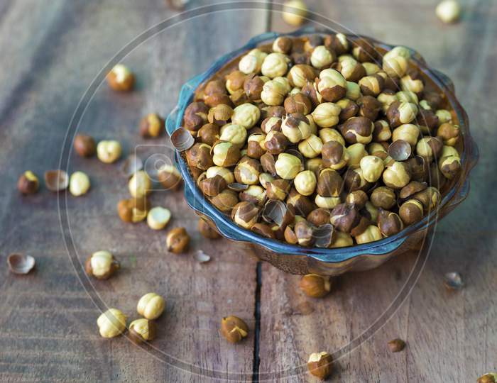 dry gram or chickpea on a bowl with wooden background
