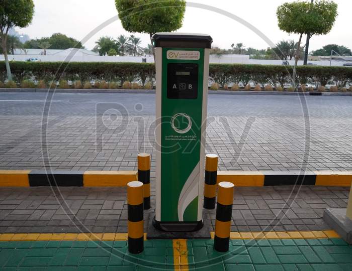 Smart Dubai Car Charging Stations In Parking Lot. Charging Modern Electric Cars (New Energy Vehicles, Nev) On The Street Station. Power Supply. Electric Car Charging Station - Dubai Uae December 2019