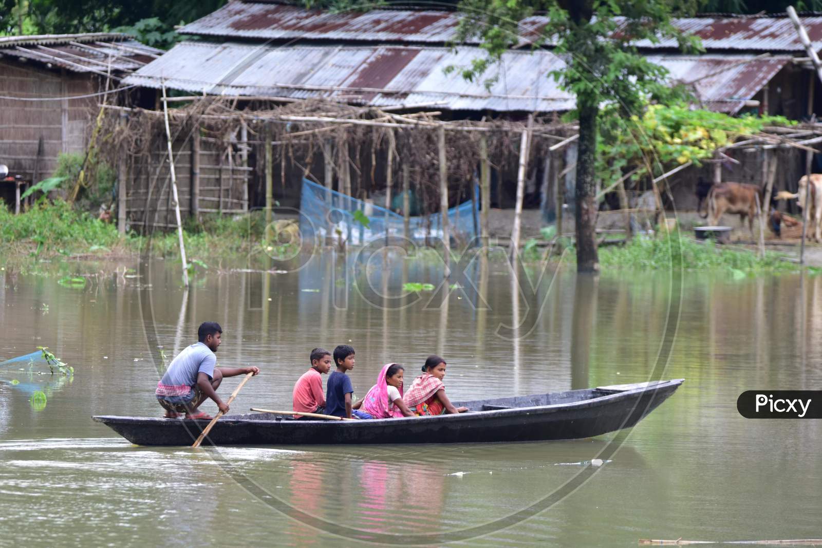People Move On A Boat Over Floodwaters Following Heavy Rainfall At Bhurbandha Village In Nagaon District Of Assam On June 27,2020.