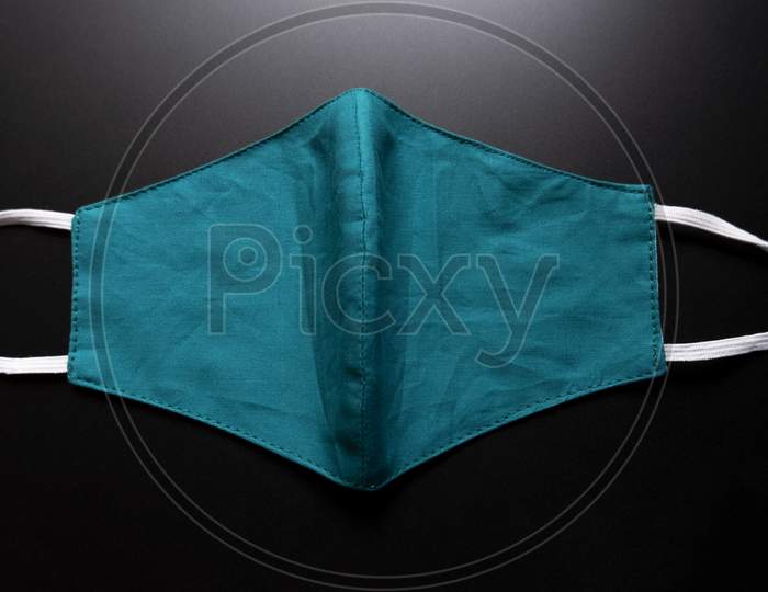Opened Green Colored Face Mask Isolated On A Black Background