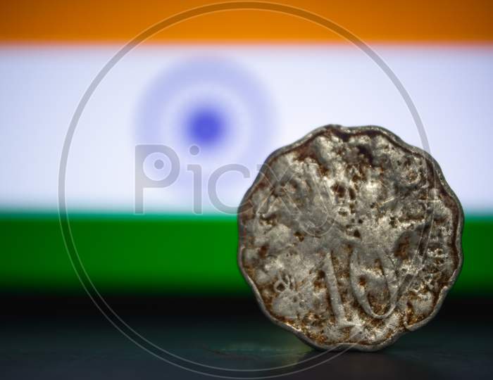Indian Currency - Indian 10 Paisa Coin Rupee Isolated On India Flag Background. Old Ten Paisa Coin With Space For Copy Text.
