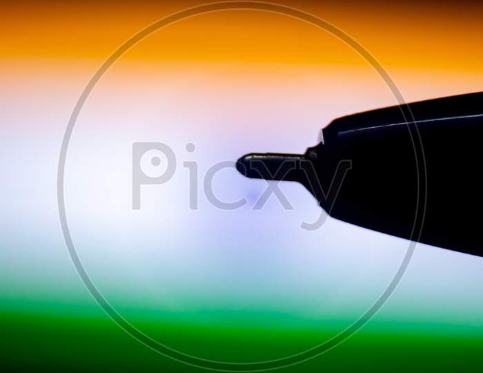 Close Up Of Black Ball Pen Head With Isolated On Indian Flag Color Background. Ballpoint Pen Head With Copy Space.
