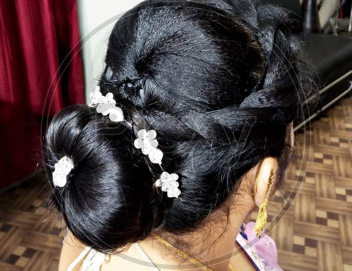 Shallow Focus Shot Of A Beautiful Hairstyle With Floral Decorations On A Brunette Female