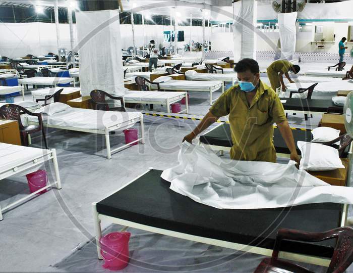 Workers prepare a bed at a recently constructed 1000 beds quarantine facility for patients diagnosed with the coronavirus disease (COVID-19) in Mumbai, India on June 22 2020.