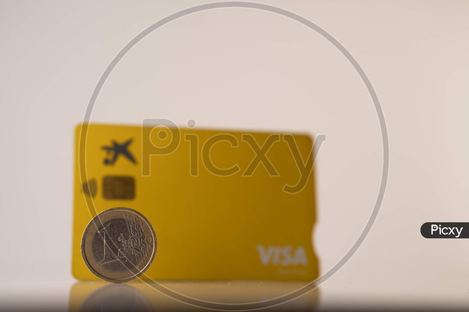one euro coin and debit visa card