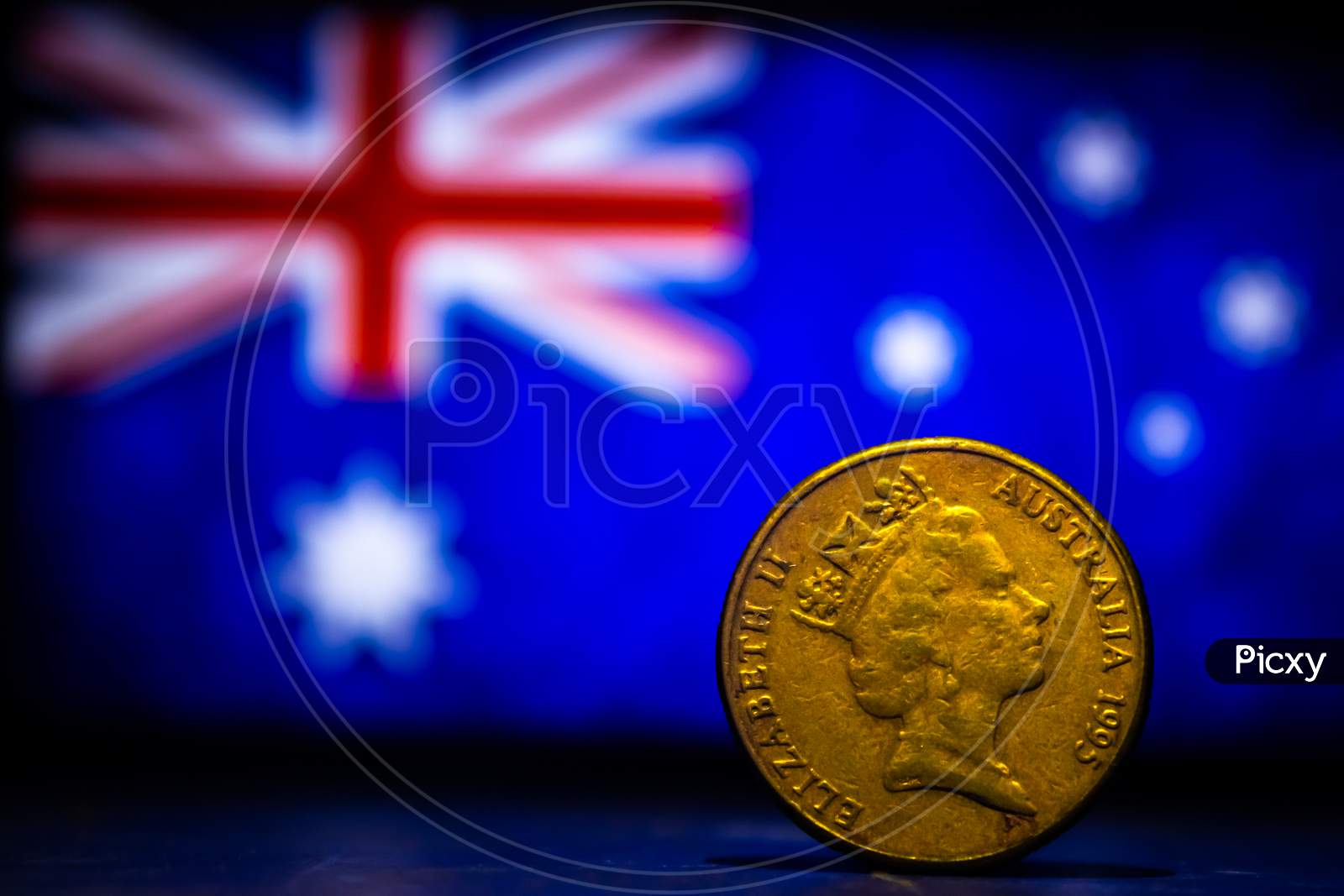 Australian Dollar Coin Isolated On Australia Flag Background With Space For Copy Text. One Dollar Coin 1995 Australian Currency. Old Coins Collection World Wide.