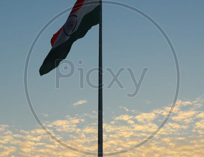 India Flag With Coludy Sky In The Background