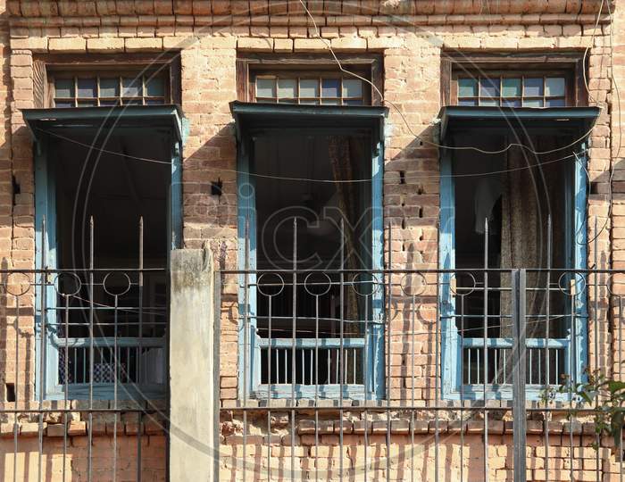 Three Windows Of Old Building Opened