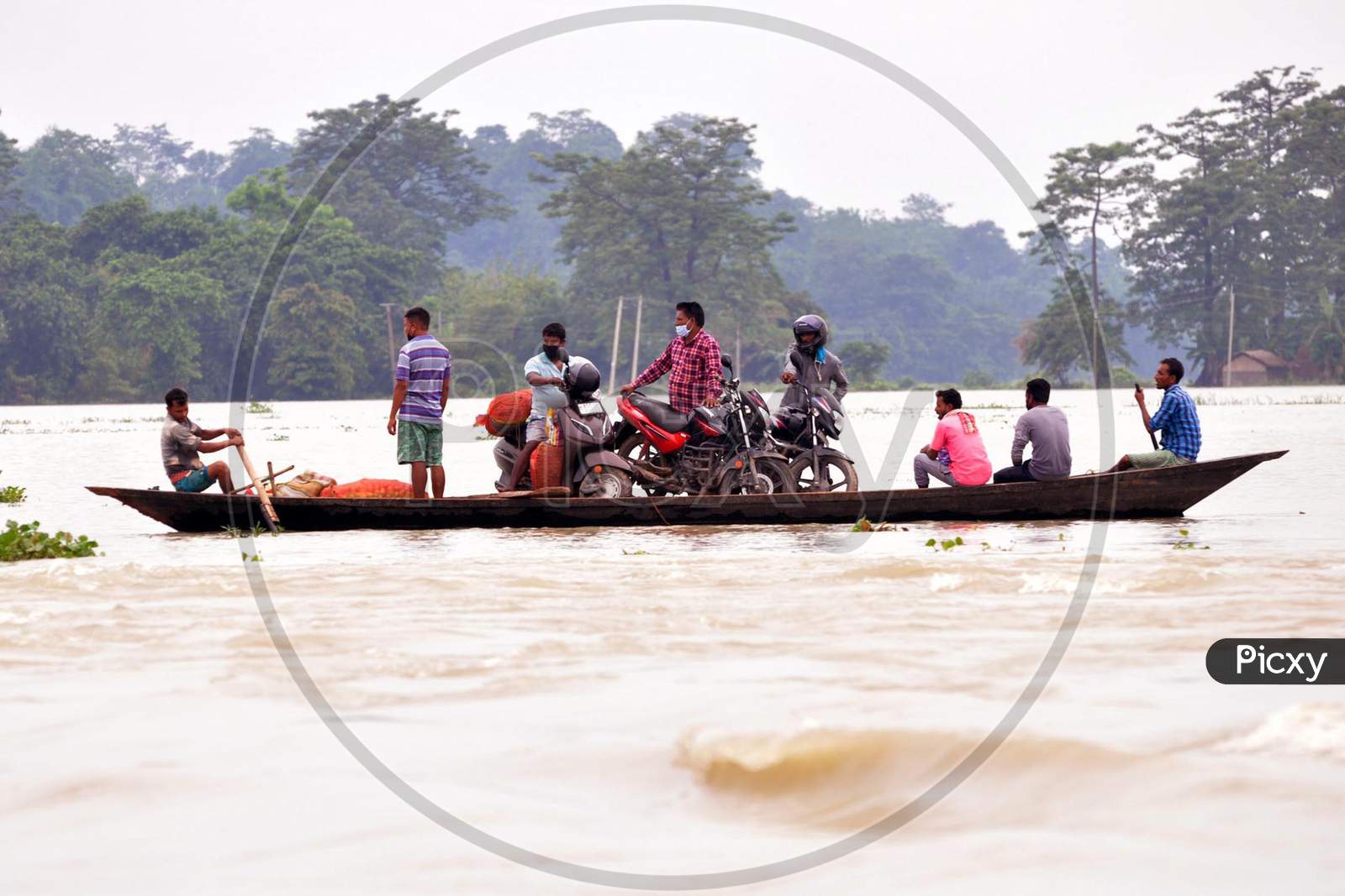 Villagers Use A Boat To Cross A Flood Waters  In Morigaon District In The Northeastern State Of Assam on june 28,2020.