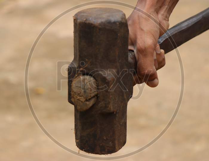 Big Hammer Which Is Old And Rusty With Wooden Handle Held In Hand