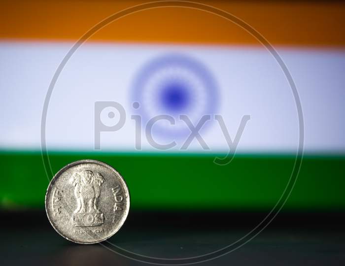 Indian Currency - Indian 10 Paisa Coin Rupee Isolated On India Flag Background. Old Ten Paisa Coin With Space For Copy Text.