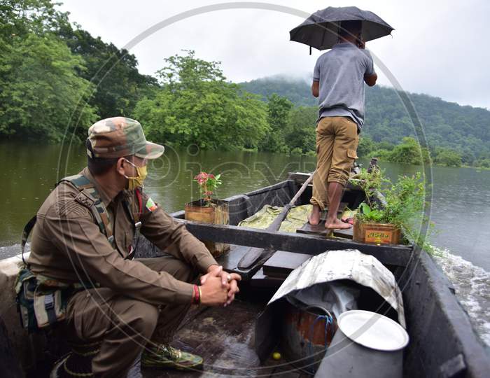 Forest guards patrol inside the flooded Kaziranga national park  in Nagaon district in the northeastern state of Assam on june 28,2020.