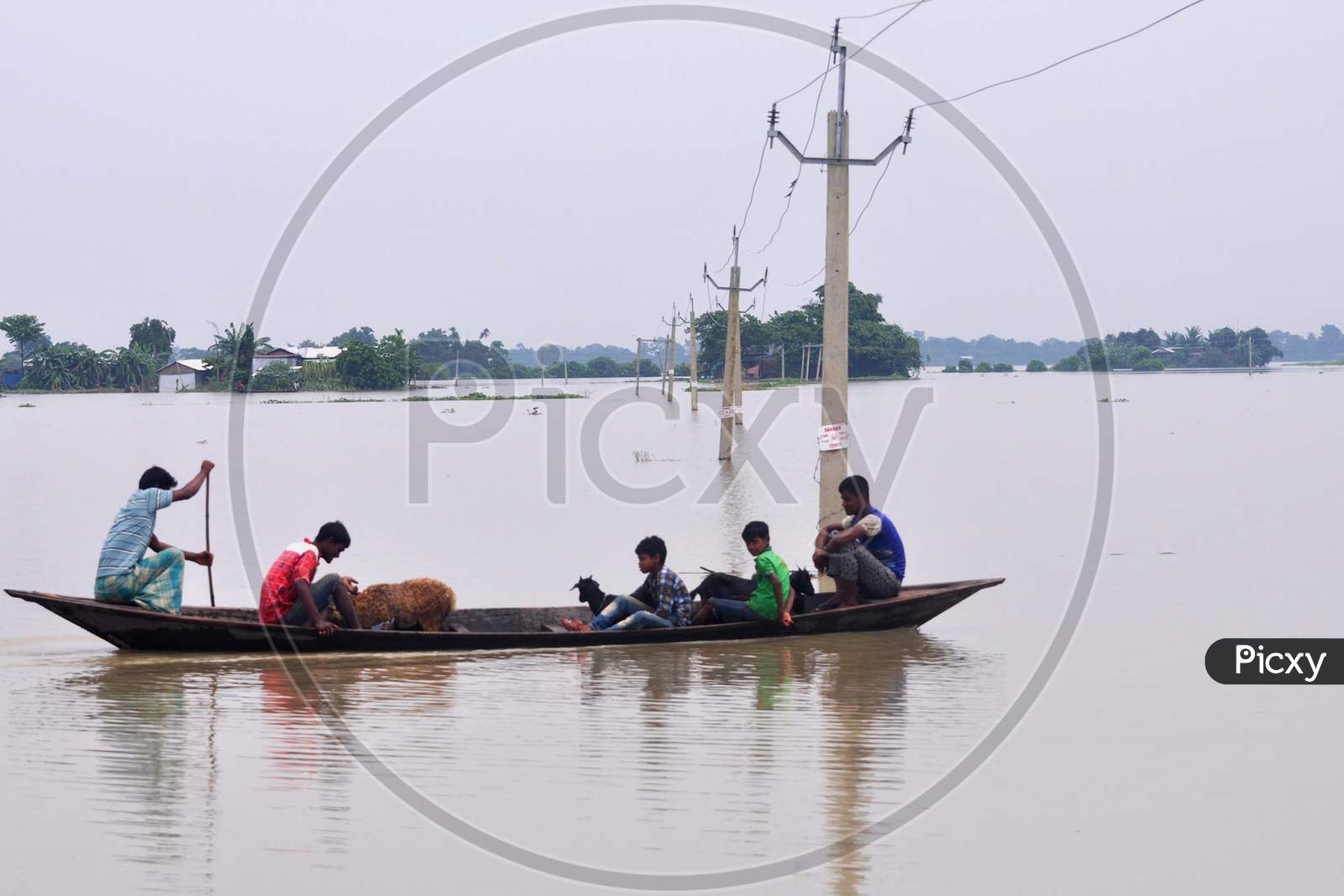 Villagers Use A Boat To Cross A Flood Waters  In Morigaon District In The Northeastern State Of Assam on june 28,2020.