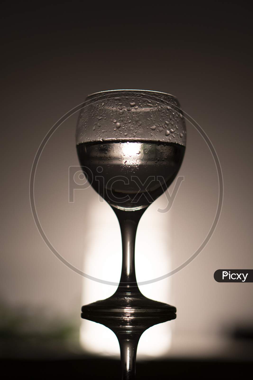 wine glass against light .
