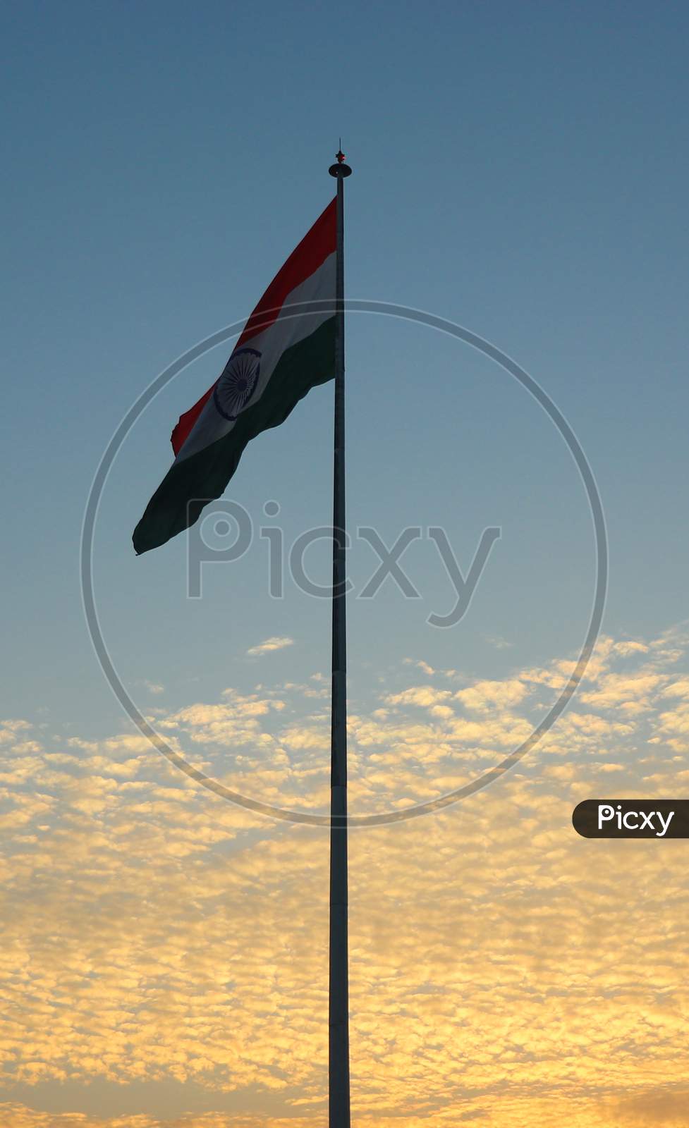 India Flag With Coludy Sky In The Background