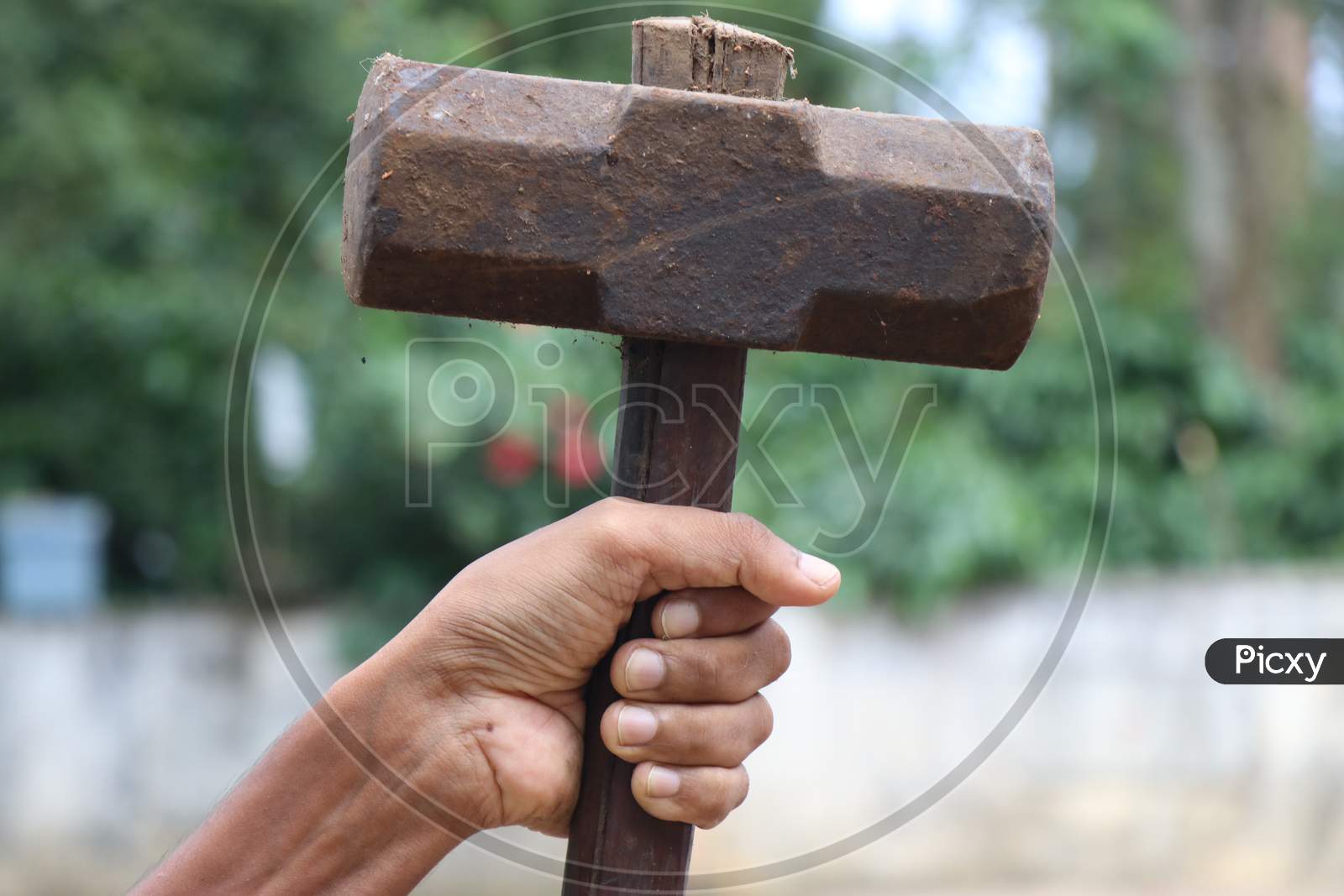 Old And Rusty Hammer Held In Hand Which Is Having Wooden Handle