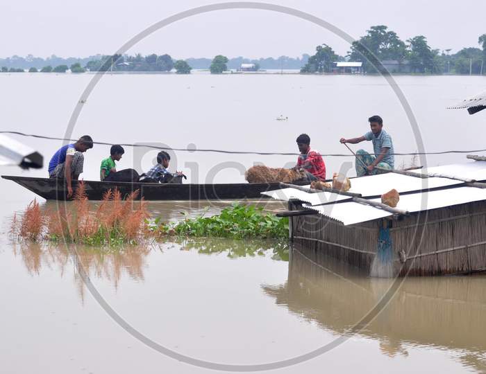 Villagers Use A Boat To Cross A Flood Water  In Morigaon District In The Northeastern State Of Assam on june 28,2020.