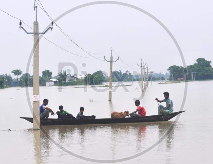 Villagers Use A Boat To Cross A Flood Water  In Morigaon District In The Northeastern State Of Assam on June 28,2020.