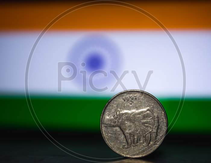 Indian Currency - Indian Twenty Paisa Coin Rupee Isolated On India Flag Background. Old 25 Paisa Coin 1979 With Space For Copy Text.