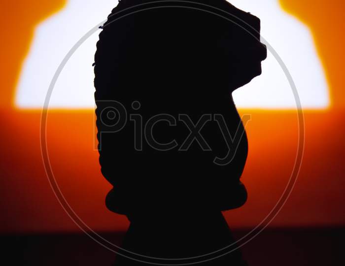 Silhouette Chess Pieces Knights Isolated On Sunrise Background. Confrontation Of Chess Pieces.Chess Pieces Knights Head.
