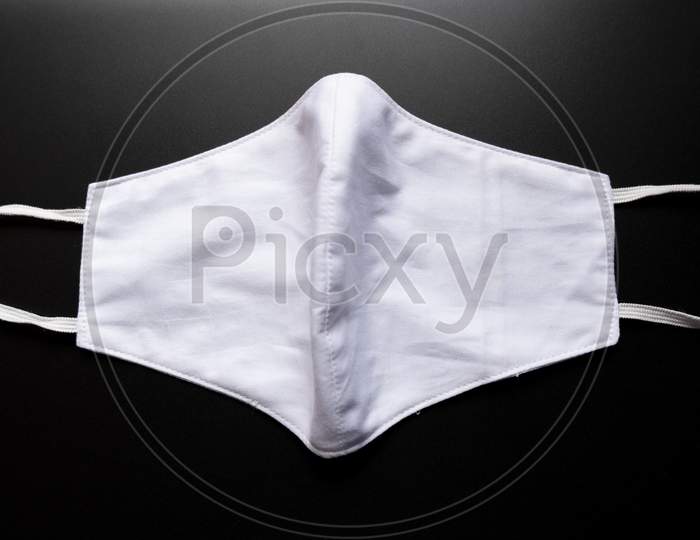 Opened White Colored Face Mask Isolated On A Black Background