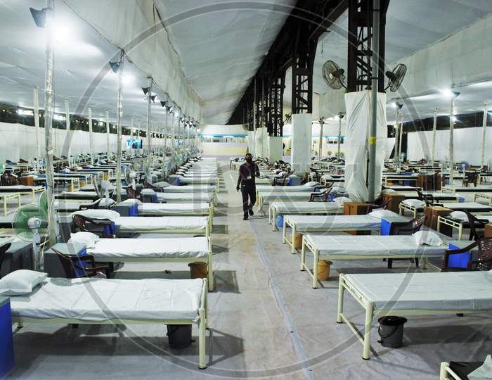 A man walks past beds in a recently constructed 1000 beds quarantine facility for patients diagnosed with the coronavirus disease (COVID-19) in Mumbai, India on June 22 2020.