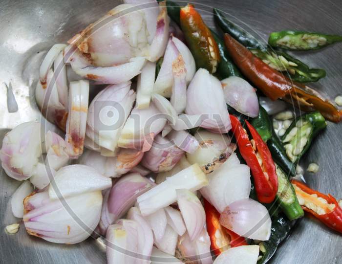 Cutting onion with pepper in the plate