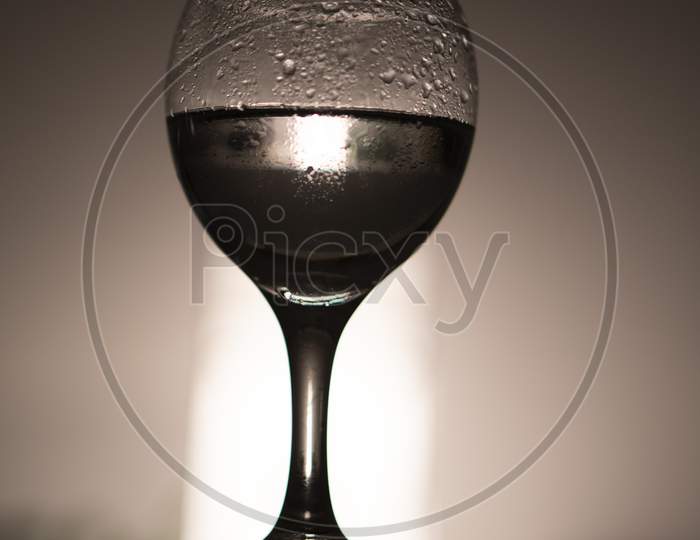 wine glass against light .