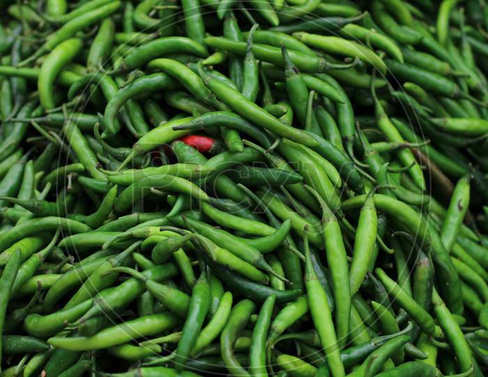 lot of green chilli in a market