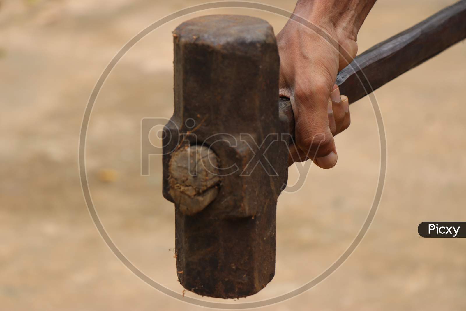 Big Hammer Which Is Old And Rusty With Wooden Handle Held In Hand