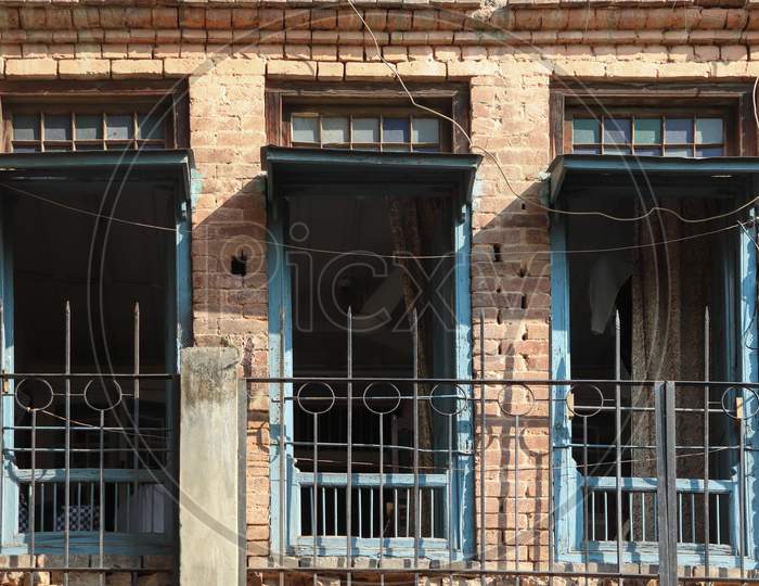 Three Windows Of Old Building Opened