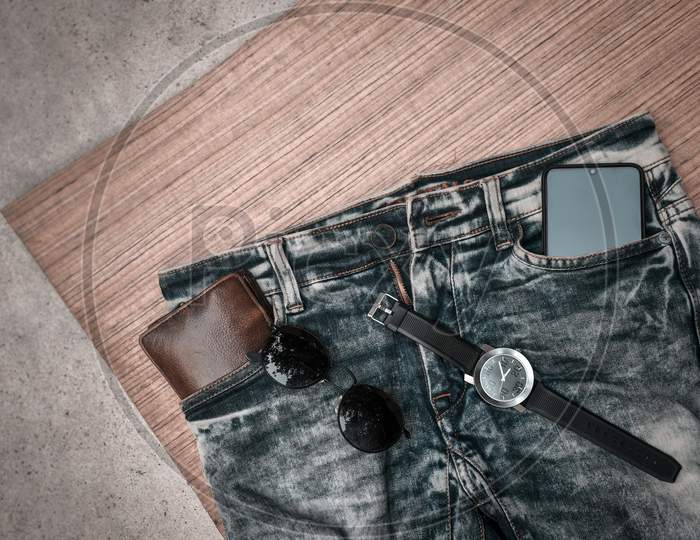 Top view accessories to travel with man clothing concept.telephone,bow tie,passport on wooden background.air plane,sunglasses,headphone,tree on wood table.flat lay.copy space.music listening.