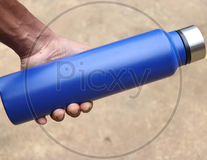 Water Flask Or Stainless Steel Water Bottle Held In Hand With Space For Branding