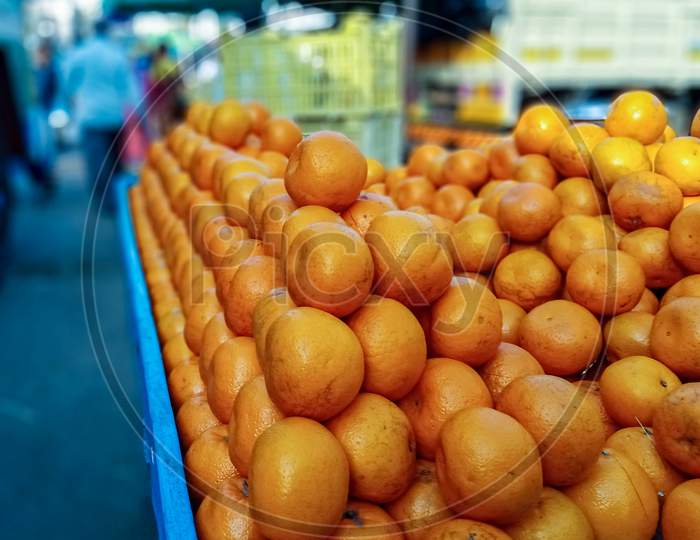 Heap Of Farm Fresh Oranges Kept On A Street Side Cart For Sale In A Indian Fruit Market.