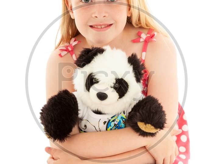 Close Up Of Beautiful Young Blonde Girl Cuddling Her Teddy Bear And Looking To Camera. Isolated On White Studio Background
