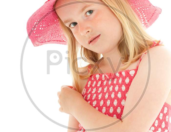 Pretty, Young Blonde Girl Wearing Pink Floppy Hat And A Polka Dot Dress. Isolated On White Studio Background
