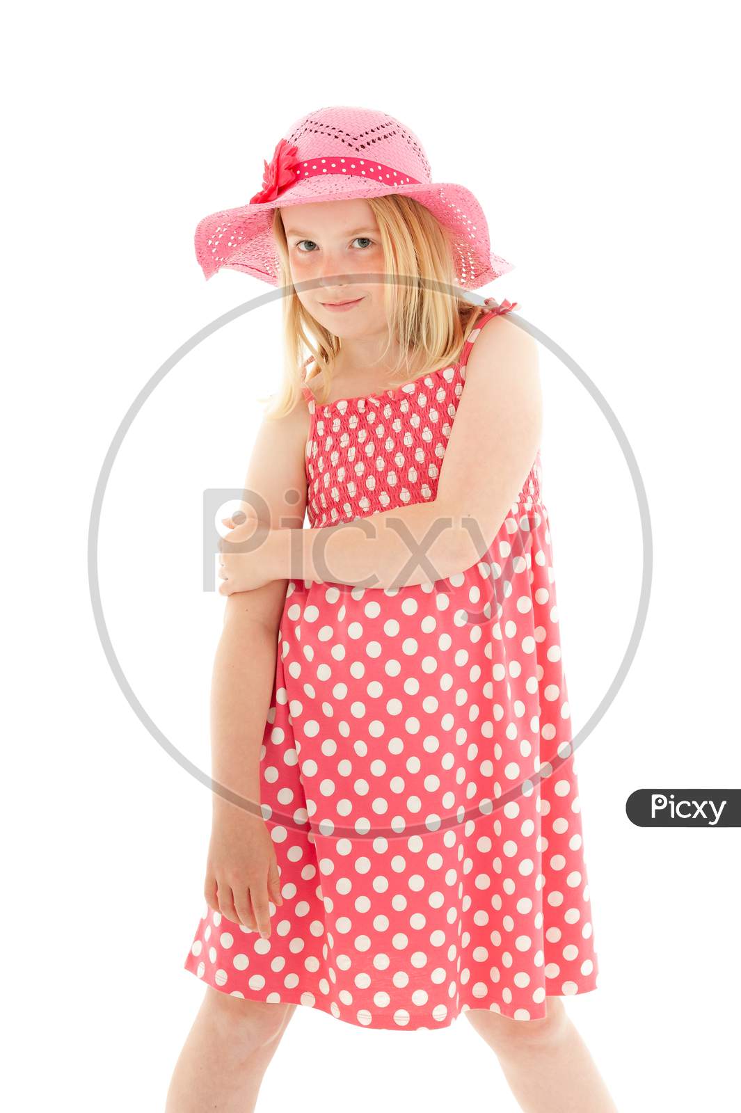 Beautiful Young Blonde Girl Wearing Big Pink Floppy Hat And A Polka Dot Dress. Isolated On White Studio Background