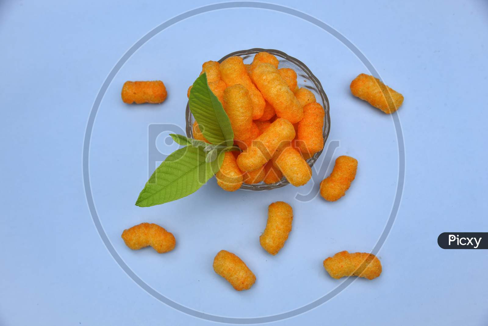 Snacks, crochets or cheese puff pastry on white background.Different kinds of popcorn in bowl