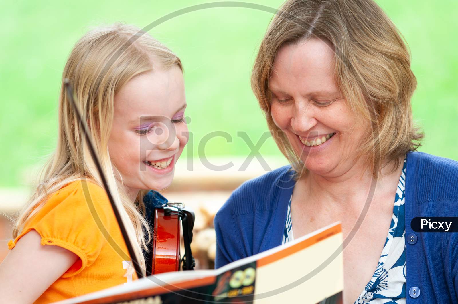 Very Happy Mother And Daughter Learning To Play Violin