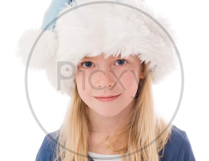 A Beautiful Young Blonde Girl In A Christmas Hat Looks Into The Camera