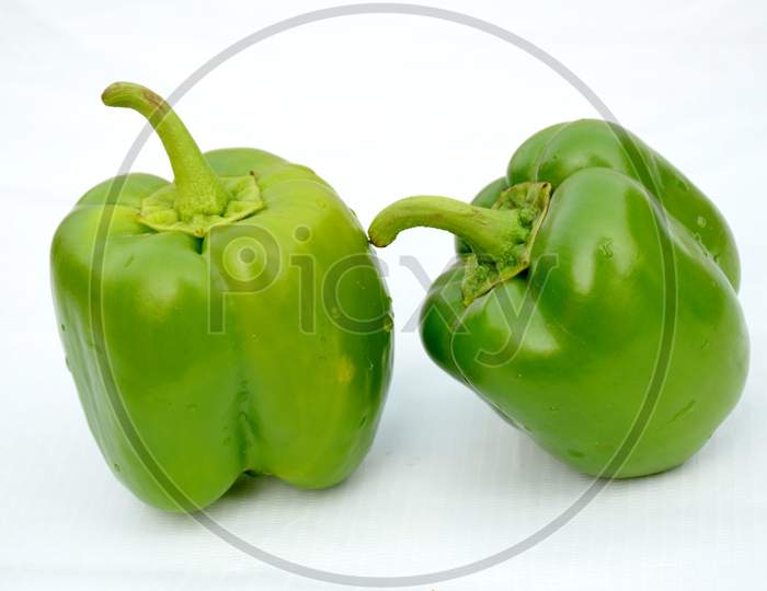 the pair green ripe capsicum  isolated on white background