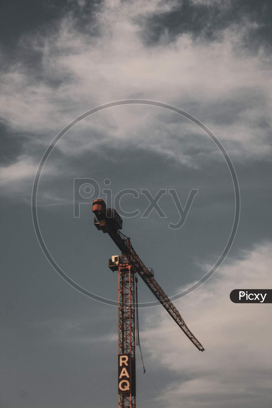 A Construction Crane On A Cloudy Day