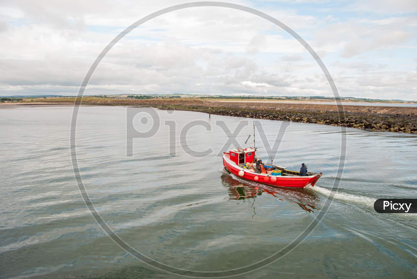 A Small Red Fishing Boat On A Calm Day