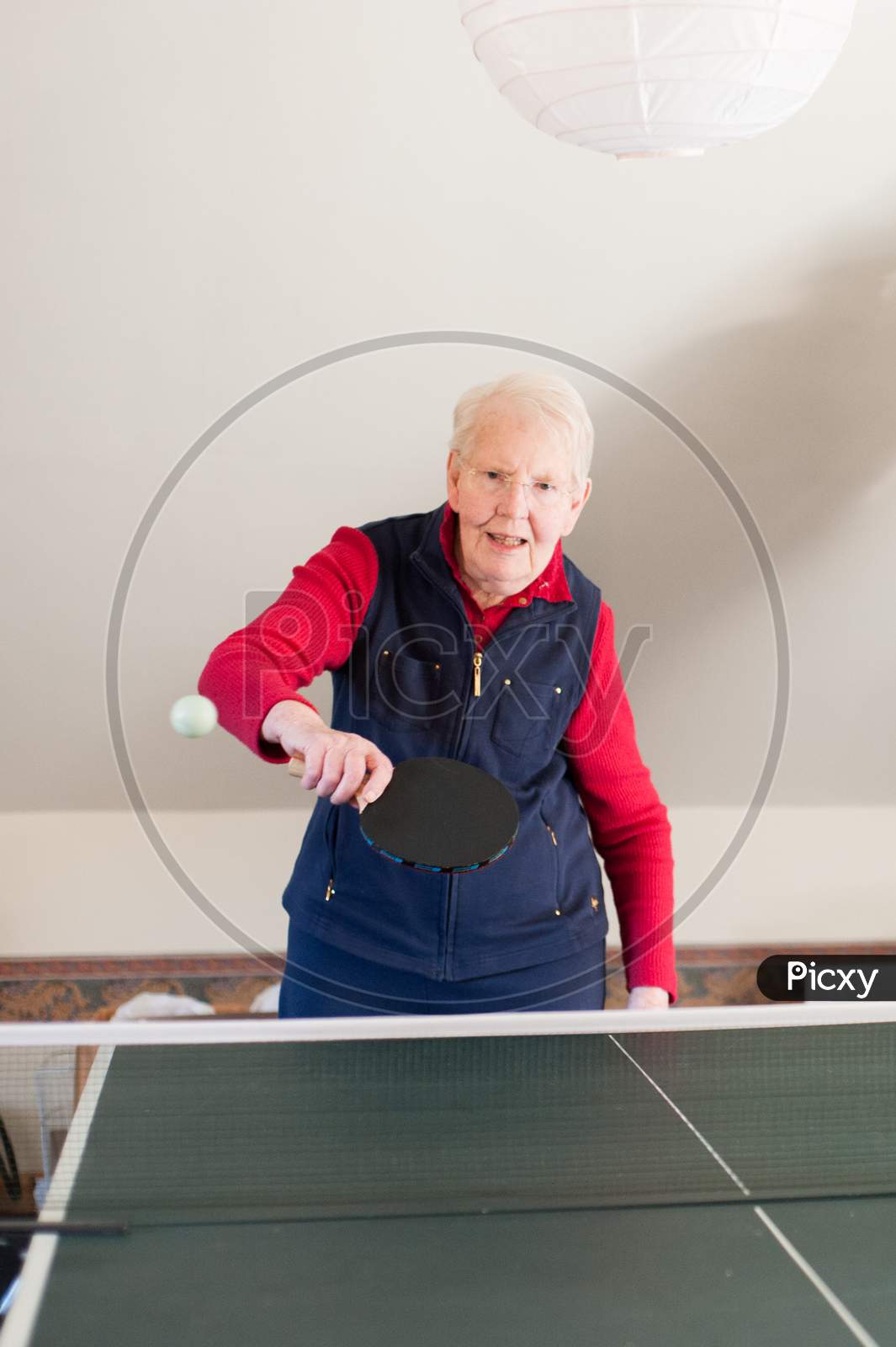 An Elderly Lady Playing Table Tennis