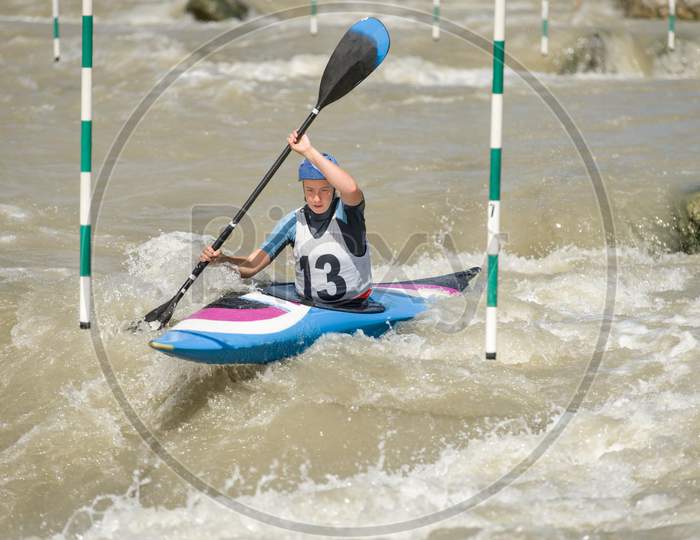 White Water Kayak Athlete Racing Through A Downstream Slalom Gate